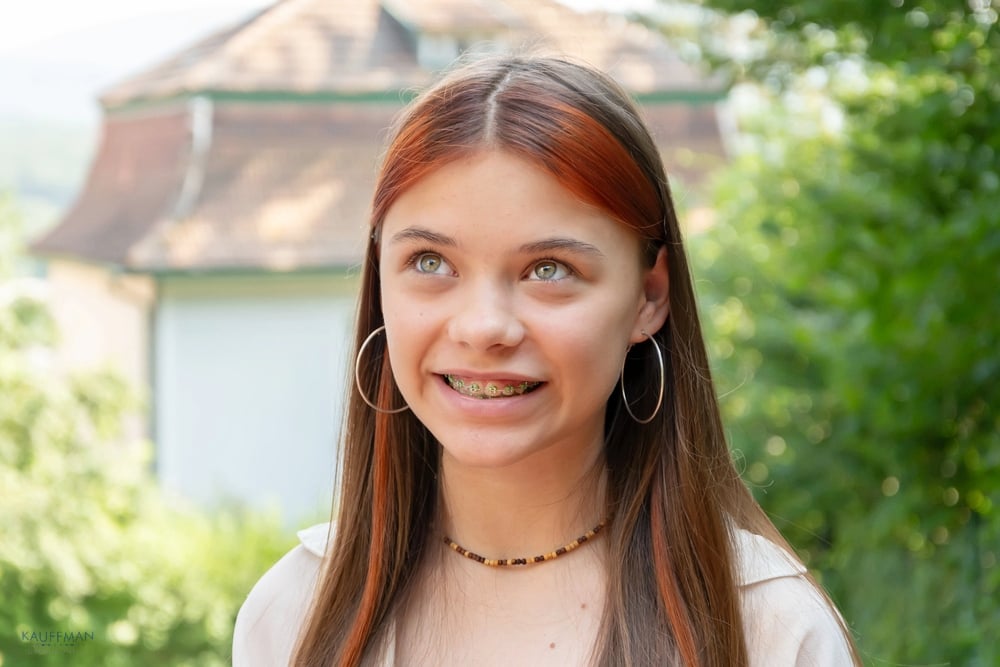 a girl with metal braces wondering about braces cost in new braunfels, tx