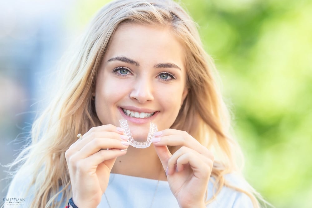 invisalign clear aligners orthodontics concept young attractive woman  - How Does Invisalign Work in New Braunfels, TX